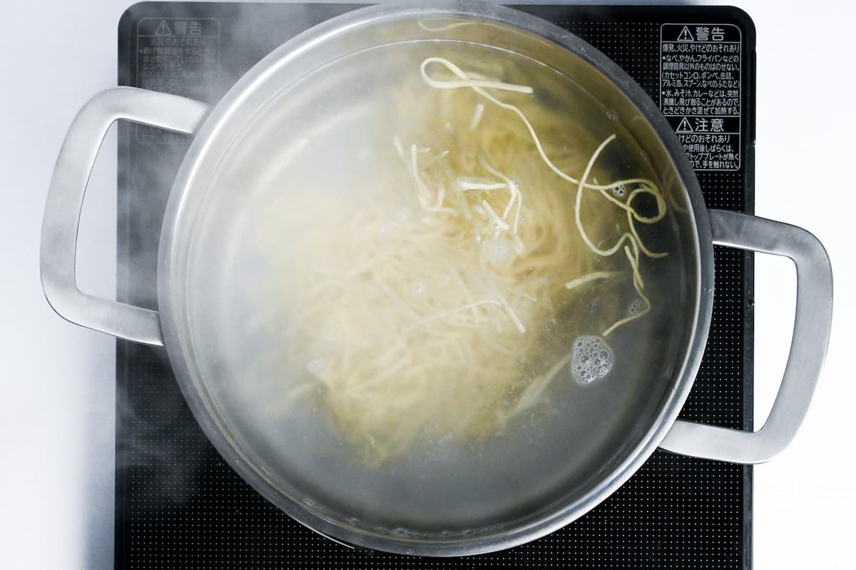 ramen noodles boiling in a large pot of water