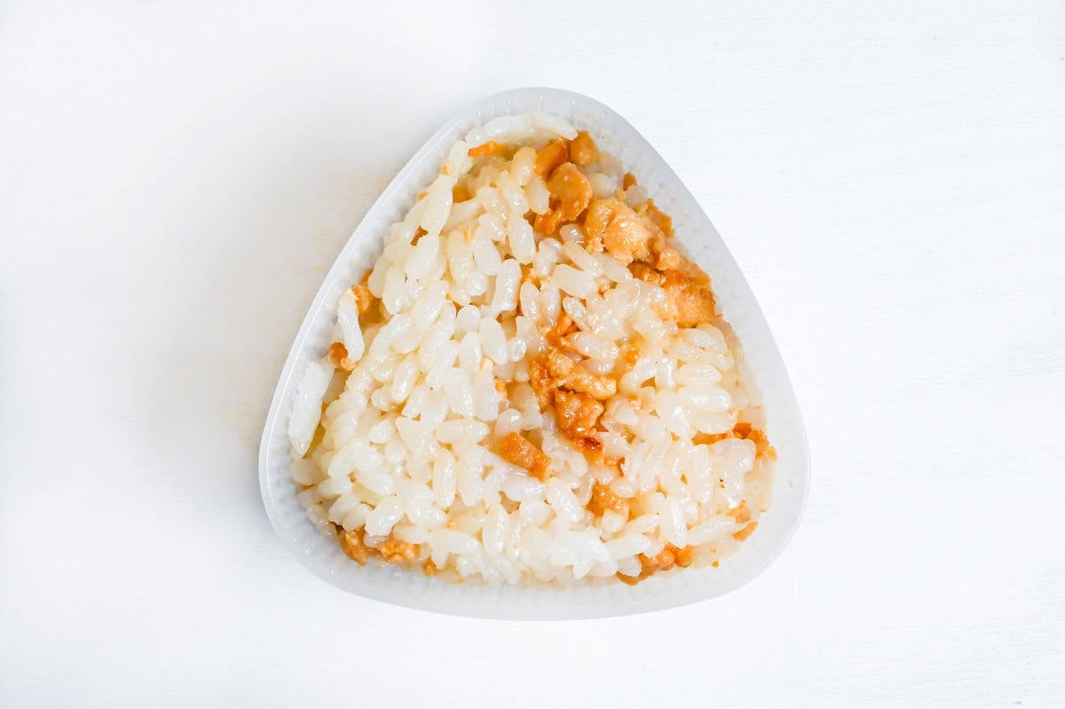 soboro chicken mixed with rice and placed in a plastic onigiri mold