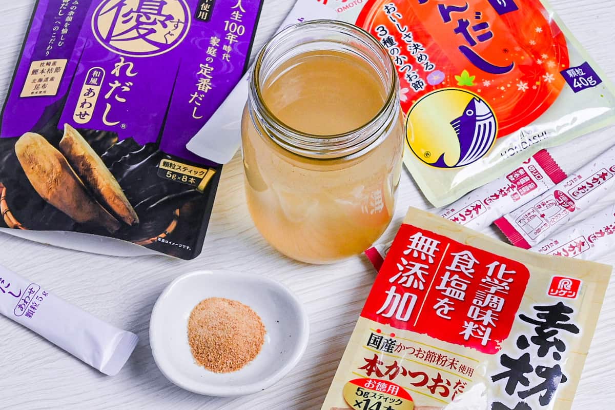 dashi made with granules in a jar surrounded by various packs of dashi granules