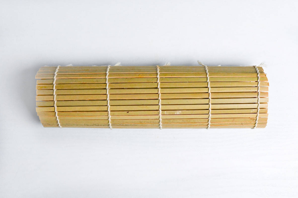 shaping dashimaki tamago with bamboo sushi rolling mat