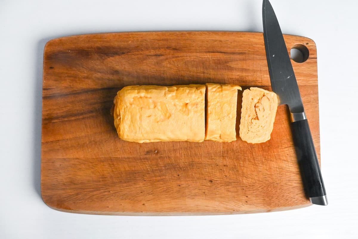 dashimaki tamago cut into slices on a wooden chopping board