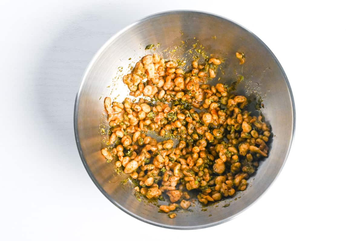 tenkasu and aonori mixed with tsuyu sauce in a bowl