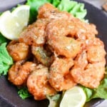 Ebi Mayo (Fried Shrimp in Mayonnaise Sauce) on a brown plate with salad and lemon wedges