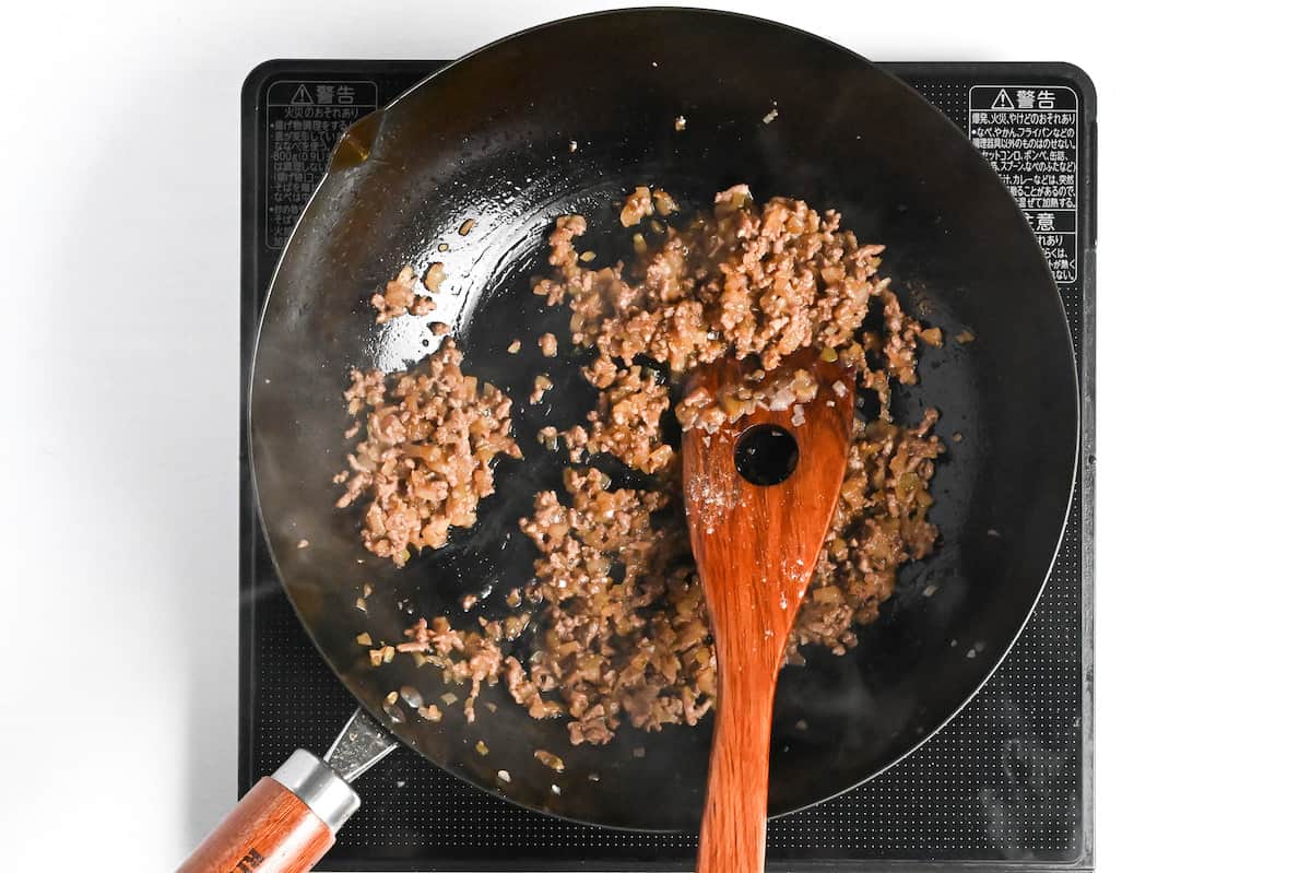 seasoned ground meat and onion frying in a pan