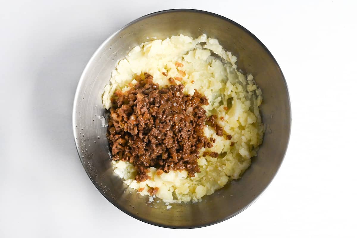 seasoned ground beef and onion mixture added to mashed potato