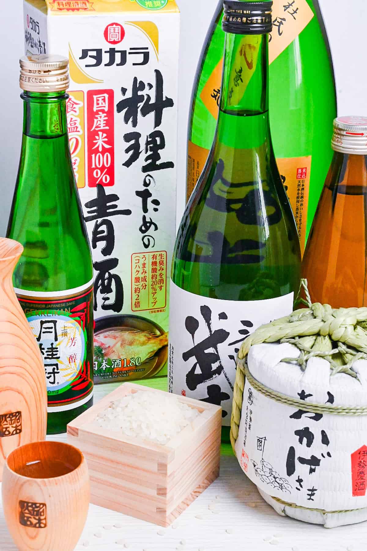 various bottles of sake, cooking sake, sake in a wooden cup and rice in a wooden box