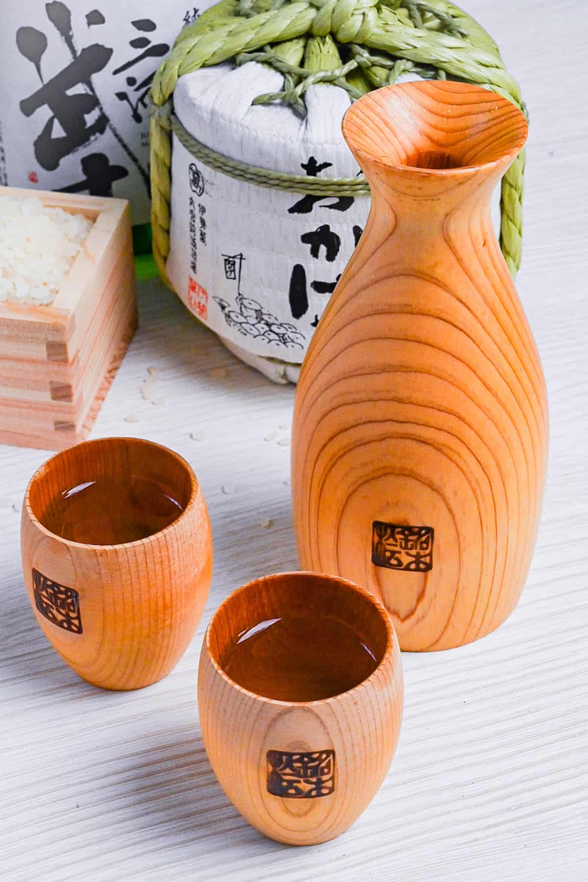 a set of wooden sake cups and pouring vessel