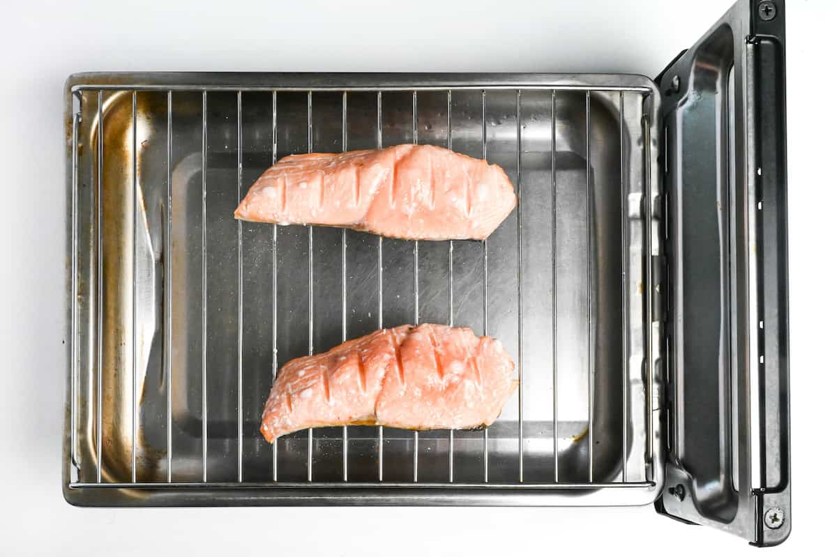 salmon fillets flesh-side up on a Japanese fish grill