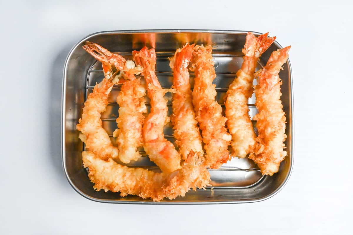 shrimp tempura resting on a wire rack