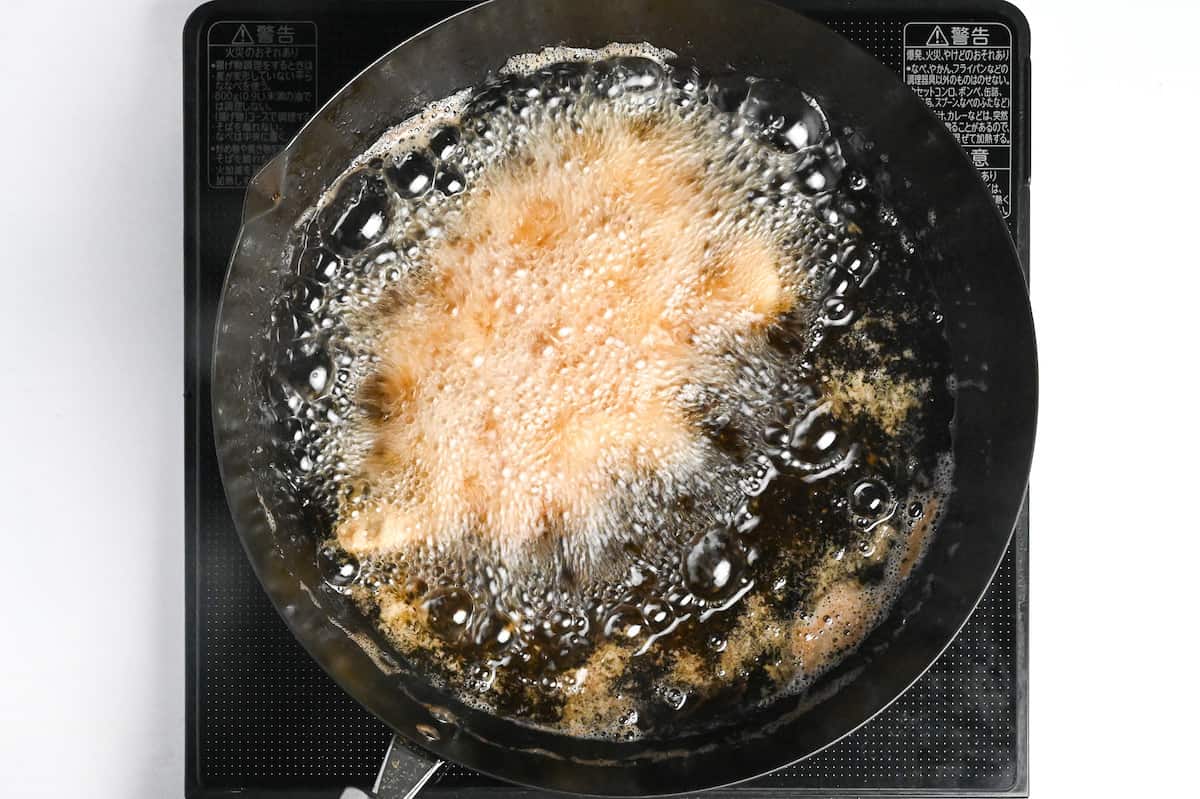 pork belly deep frying in a wok