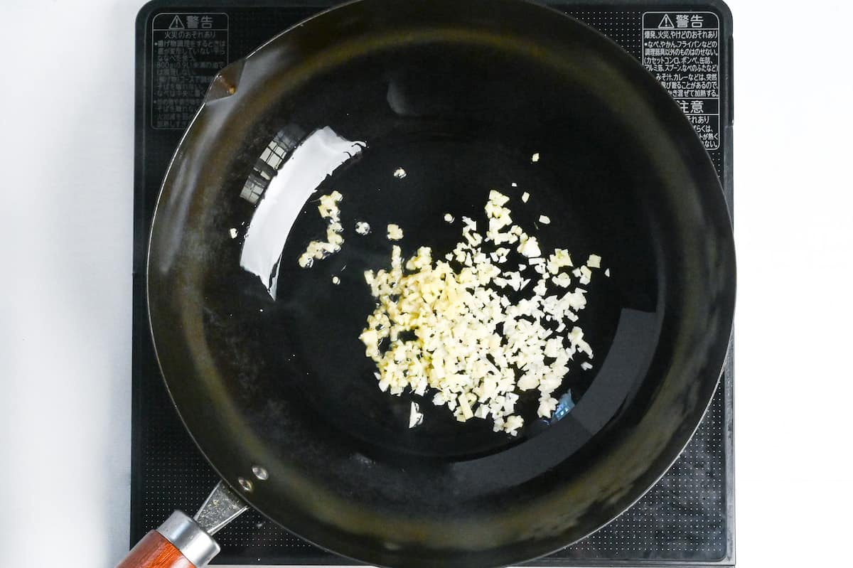 finely diced garlic and fresh ginger frying in sesame oil