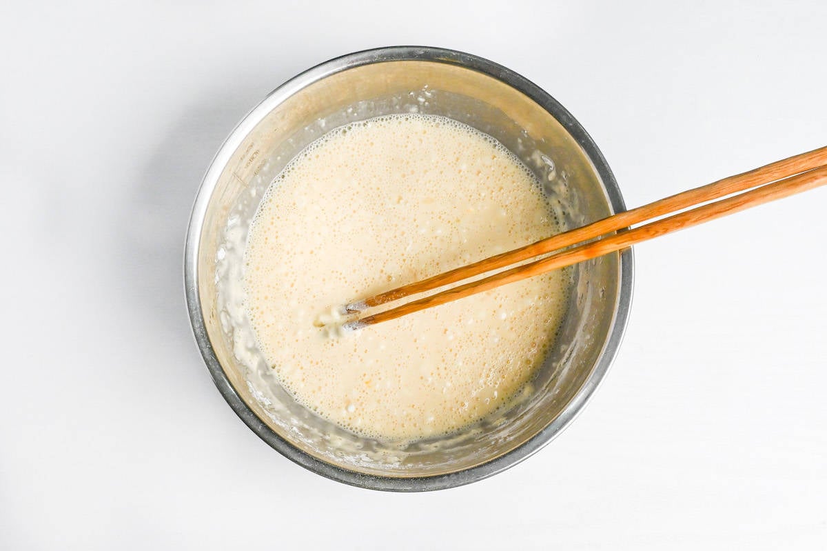 tempura batter in mixing bowl with wooden chopsticks