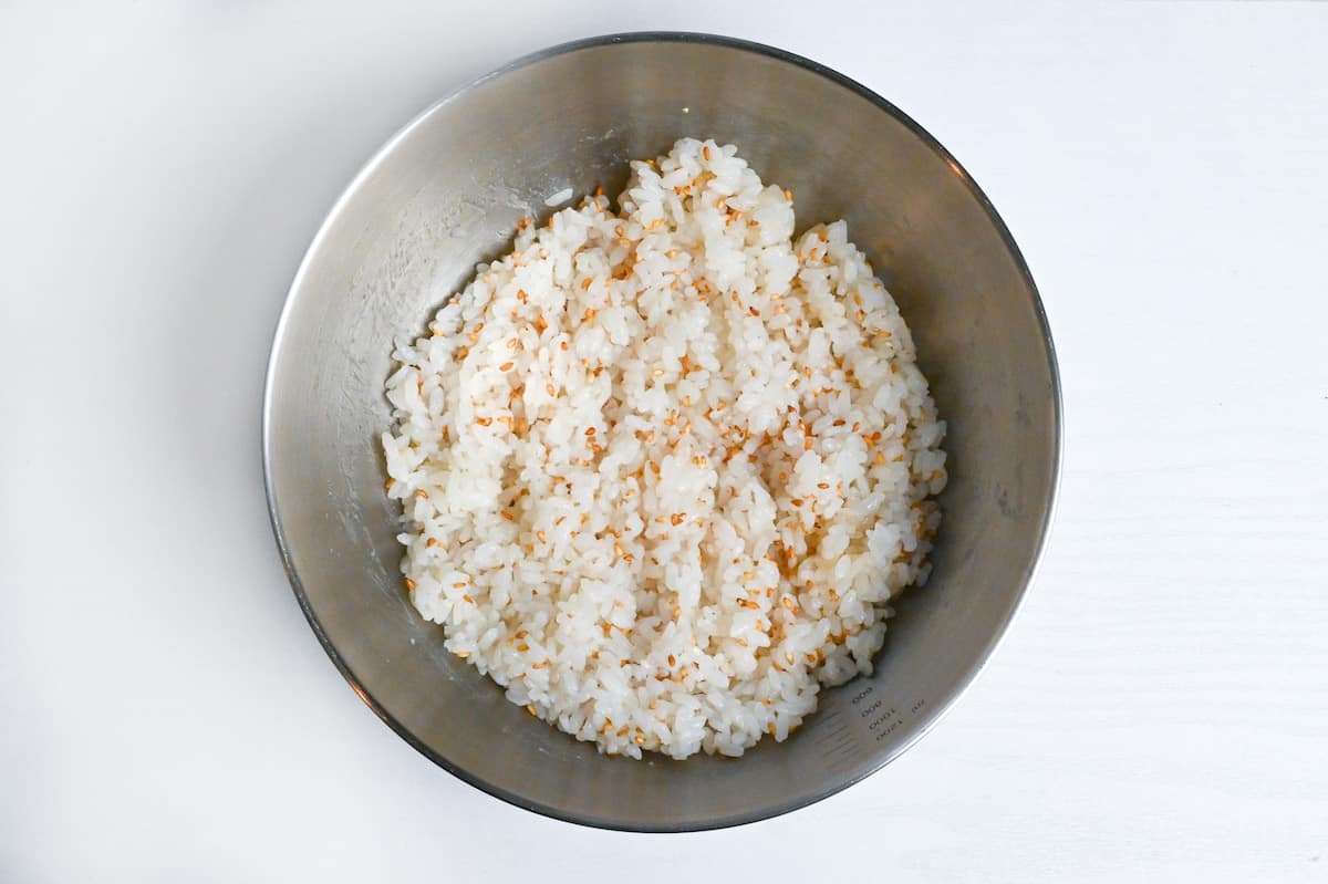 cooked rice mixed with sesame seeds in a bowl