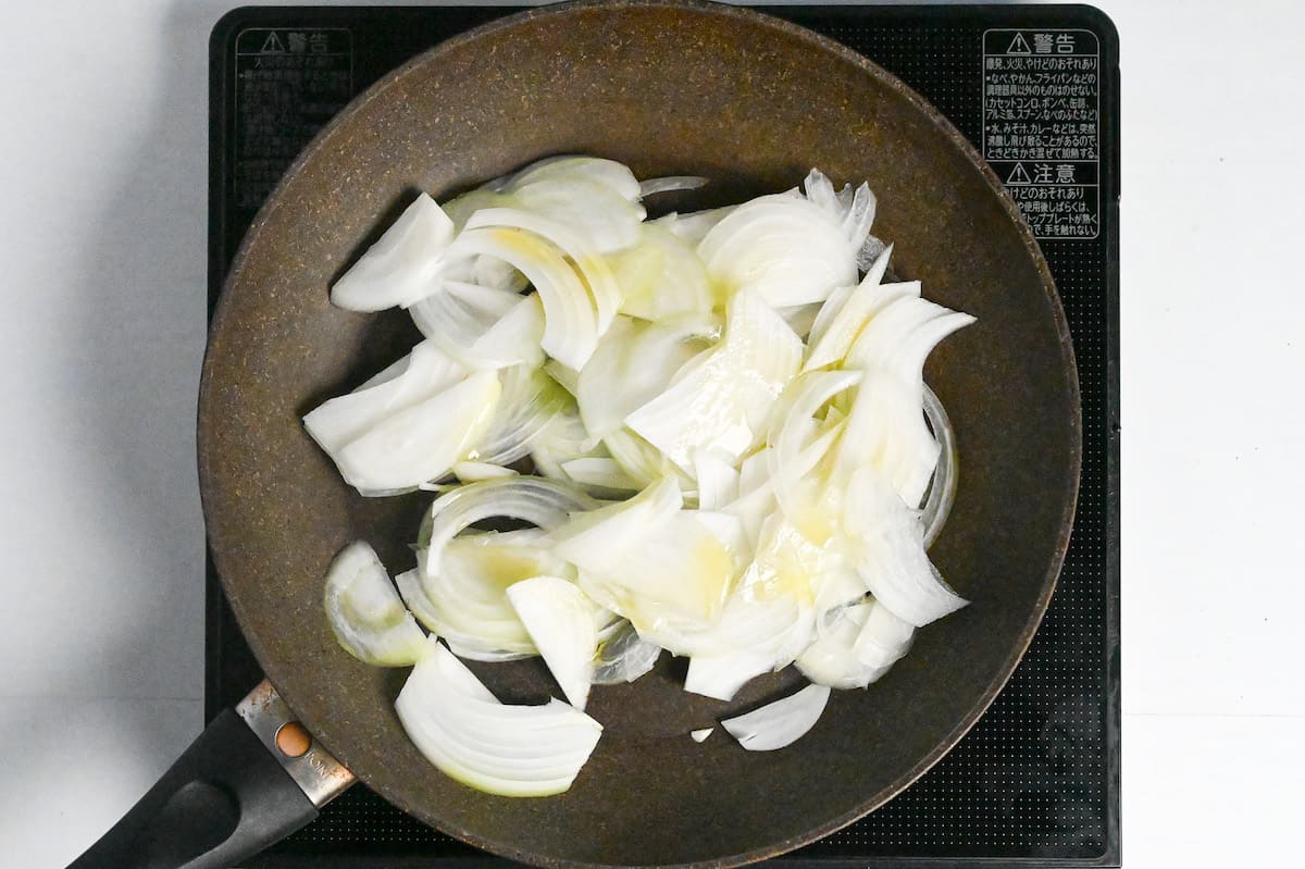 roughly cut onions in a frying pan