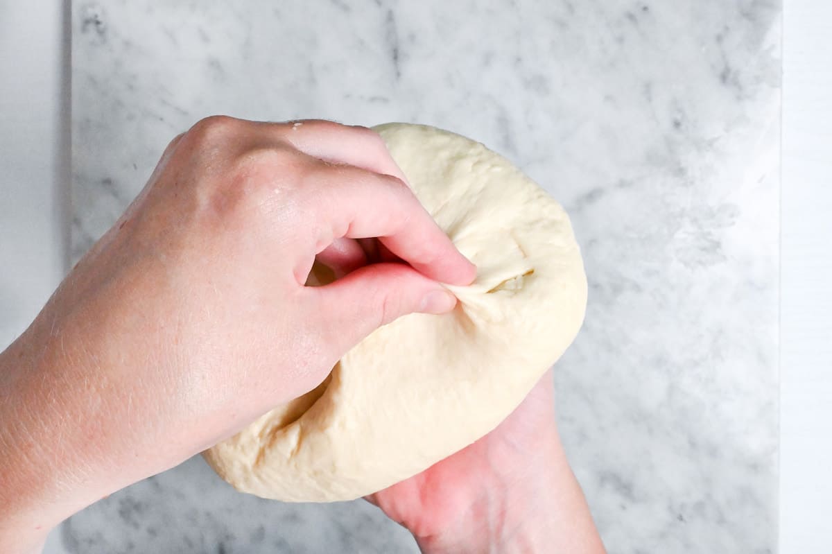 pinching underneath ball of dough to seal base