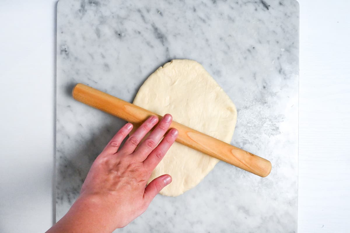 rolling out shokupan dough with wooden rolling pin