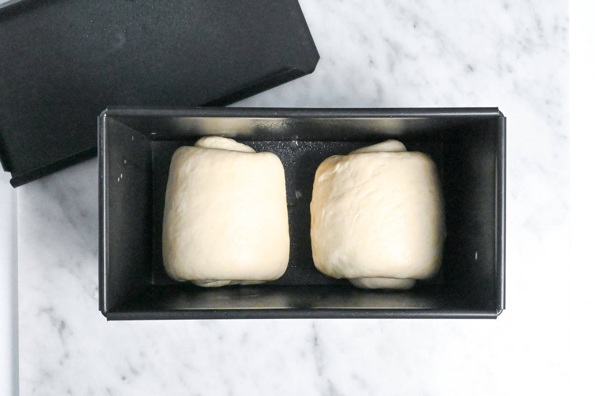 nama shokupan rolls placed in an oiled bread pan