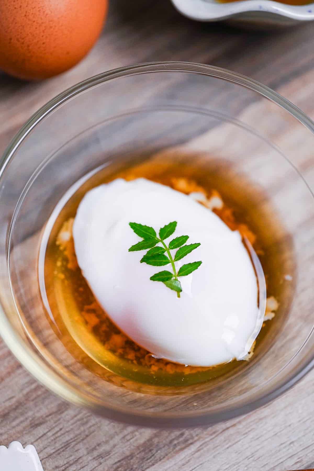 onsen tamago (Japanese hot spring egg) in a glass bowl with sauce