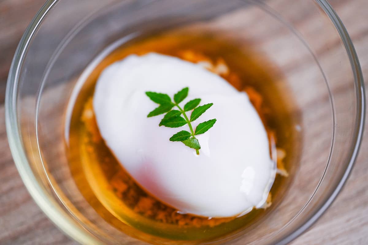 onsen tamago (Japanese hot spring egg) in a glass bowl with sauce