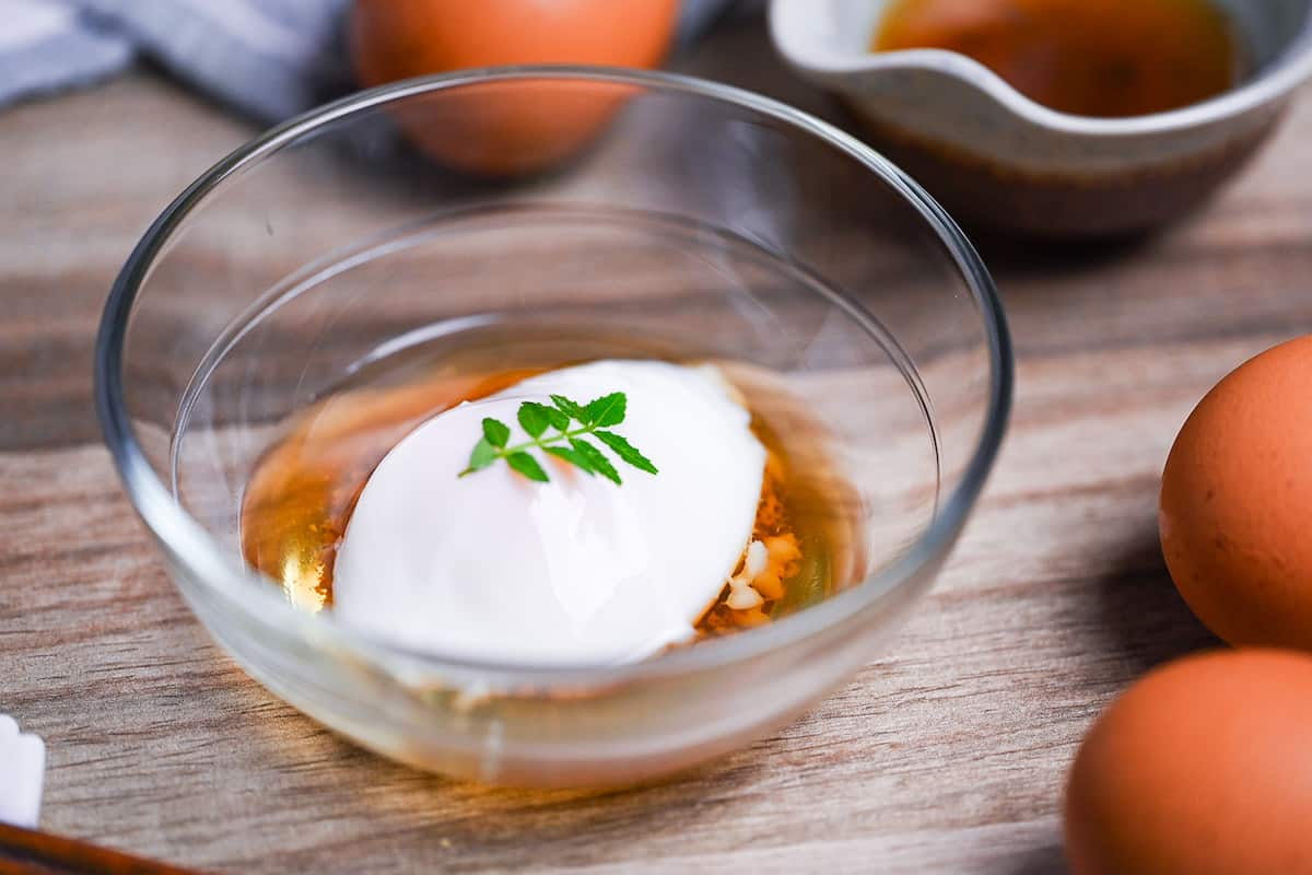 onsen tamago (Japanese hot spring egg) in a glass bowl with sauce