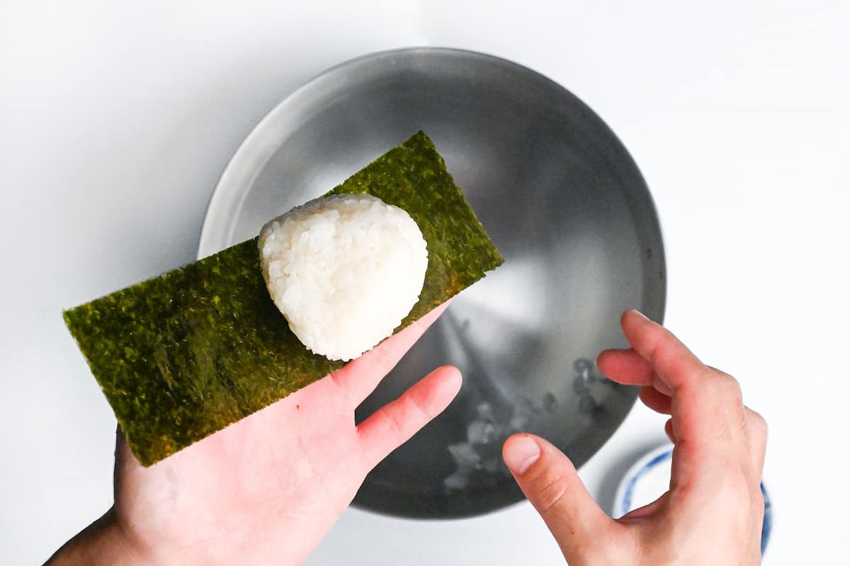 wrapping hand shaped shio onigiri with nori seaweed