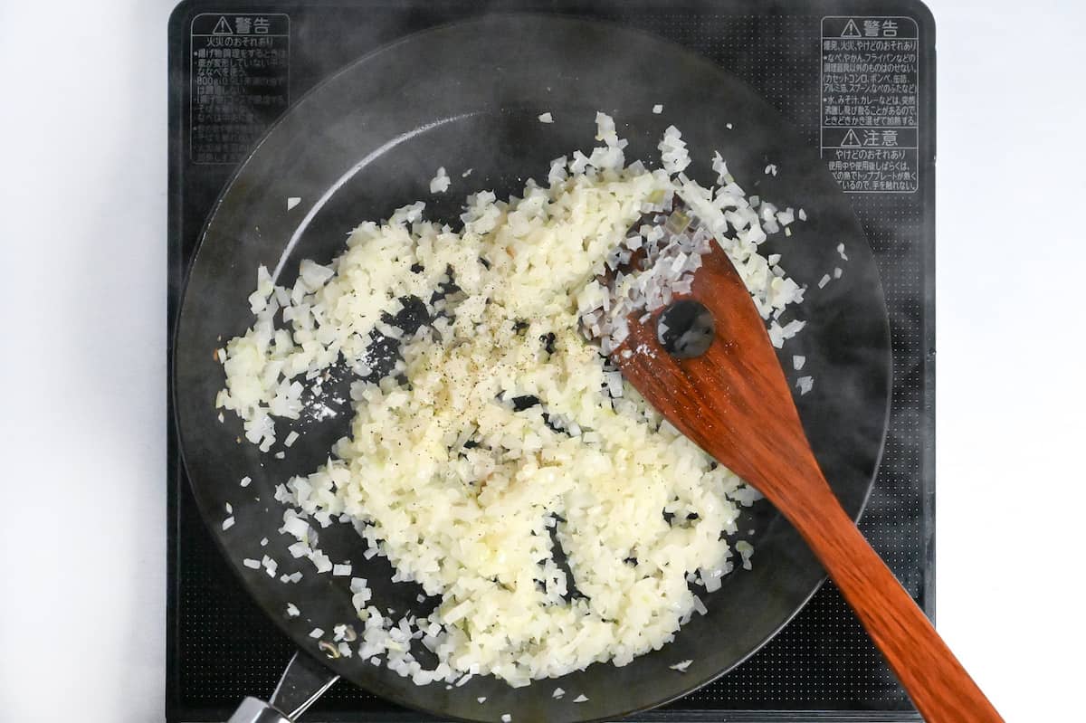 frying finely chopped onion in a pan with butter