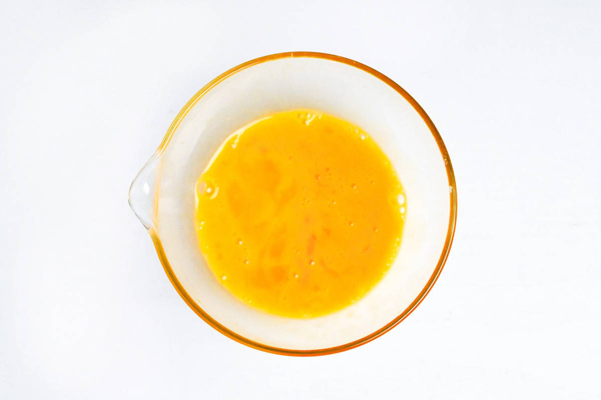 whisked egg in a small glass bowl