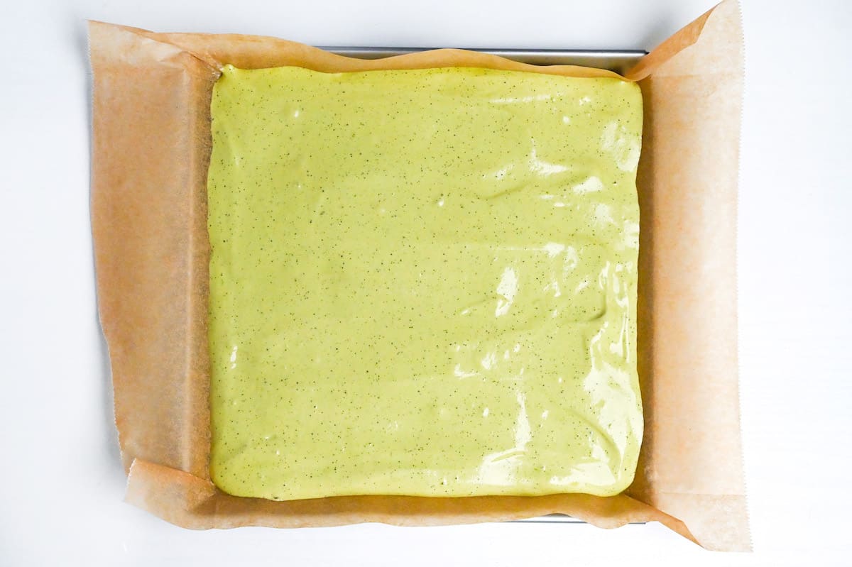 matcha roll cake batter spread in roll pan