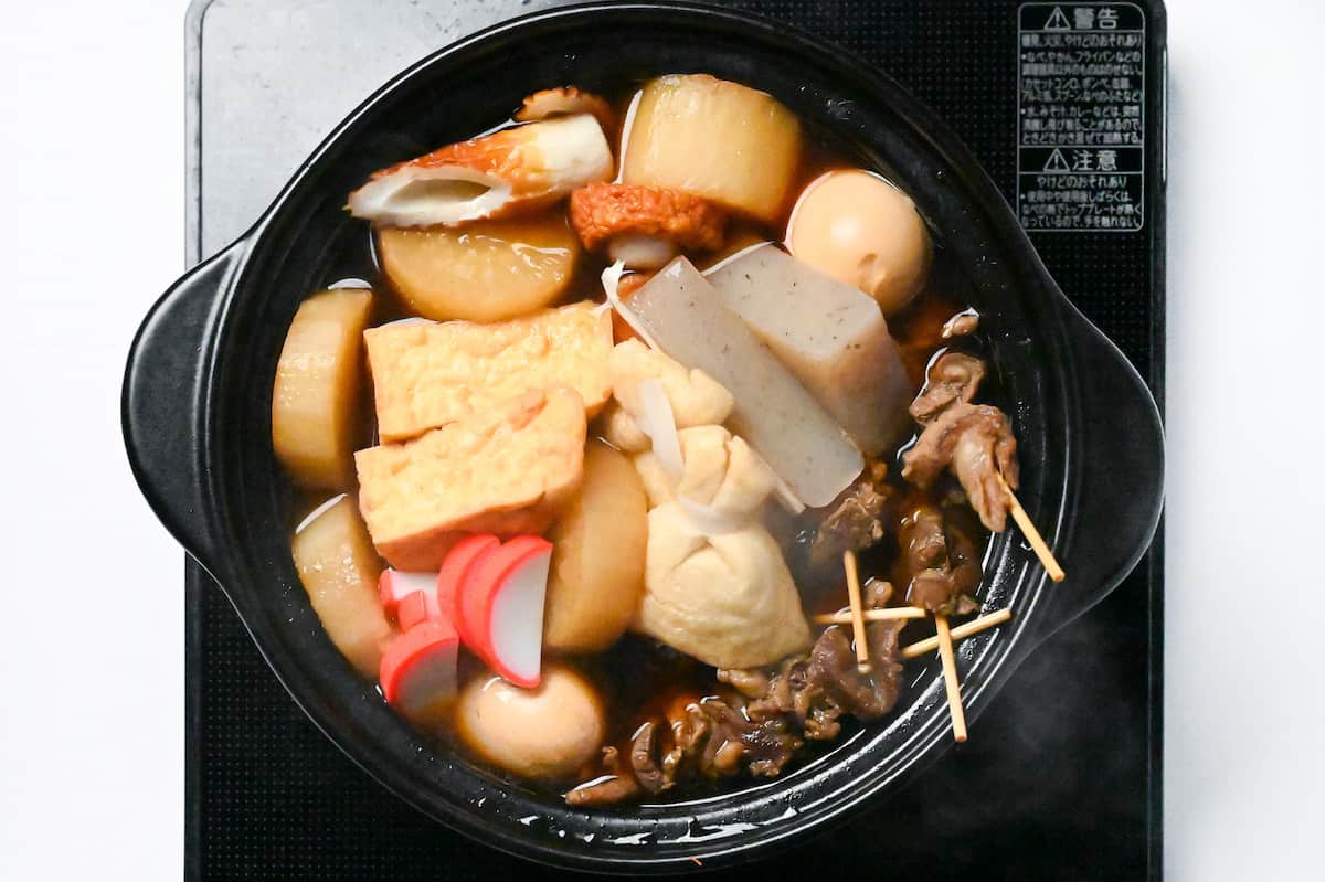 Oden with beef sinew skewers, daikon, boiled eggs, tofu, kamaboko (fishcakes), konnyaku and various Japanese fishcakes