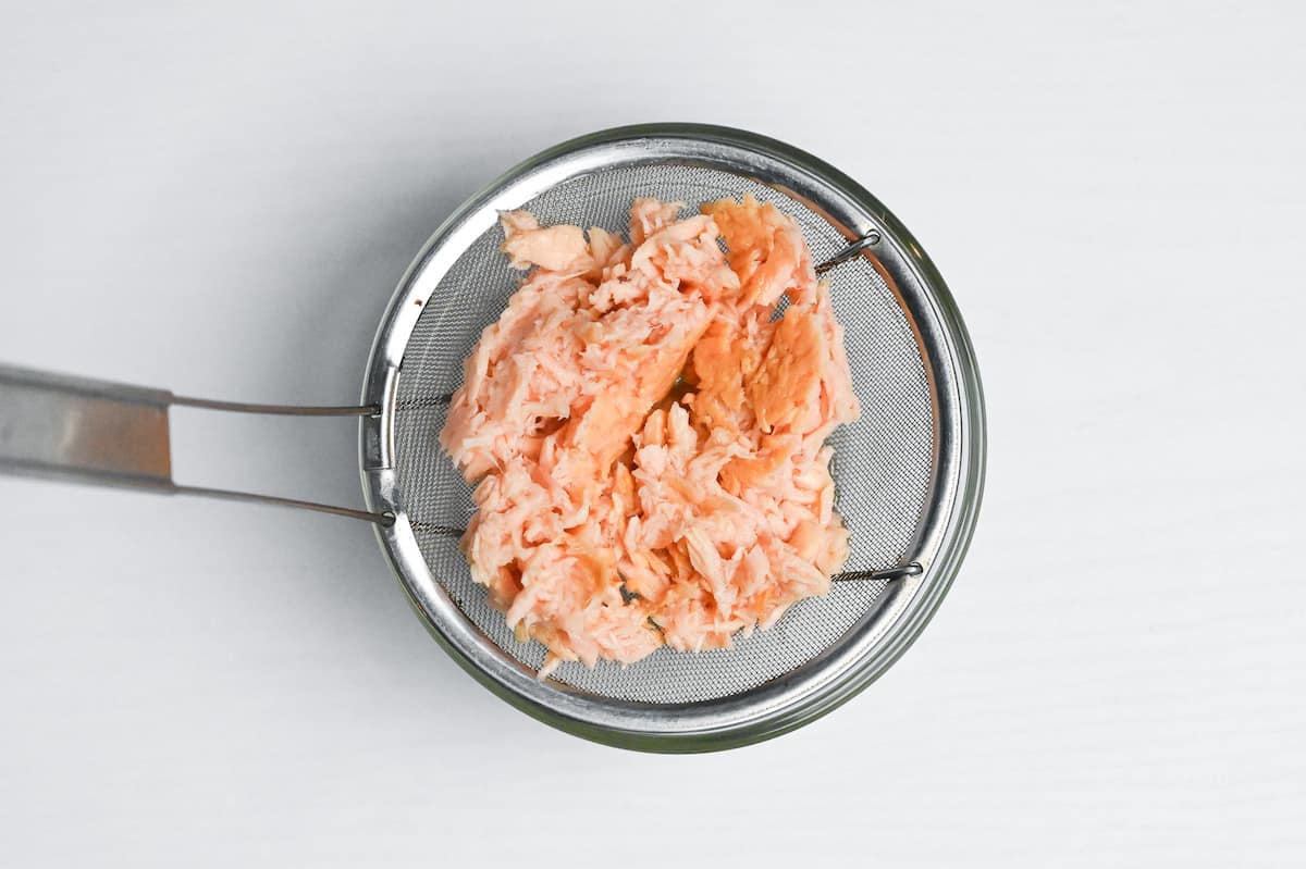 squeezing excess liquid out of canned tuna