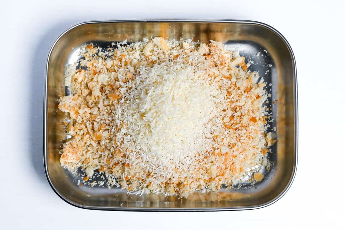 panko breadcrumbs and grated parmesan cheese in a rectangular steel container