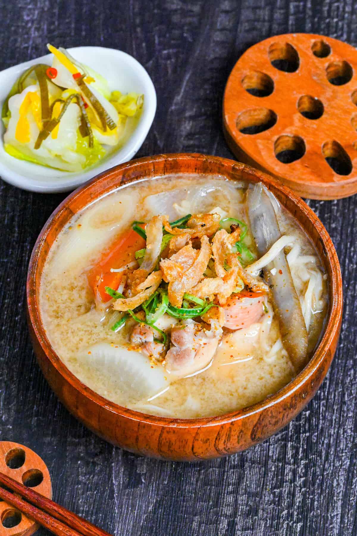 Japanese Chicken Miso Soup (Torijiru) in a wooden bowl topped with green onion and strips of crispy chicken skin