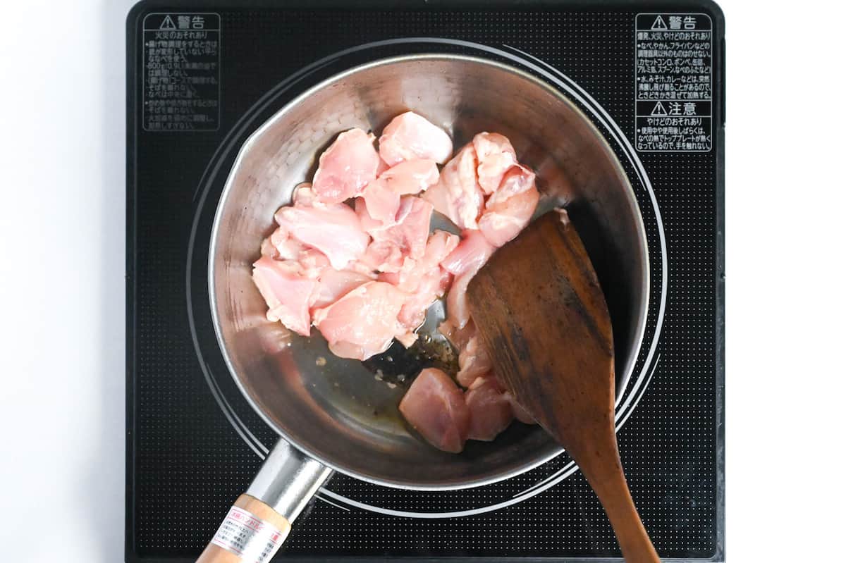 frying chicken thigh meat in a pan