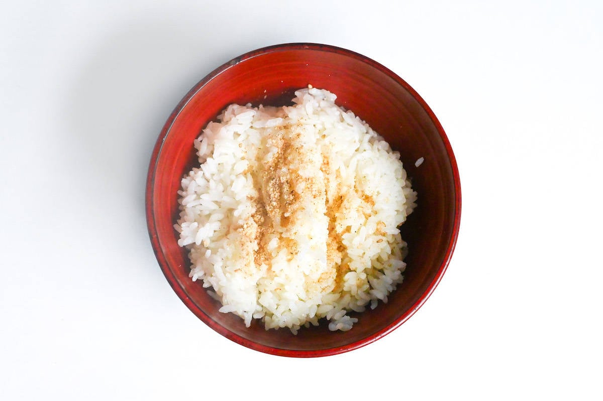 a bowl of rice sprinkled with ground sesame seeds