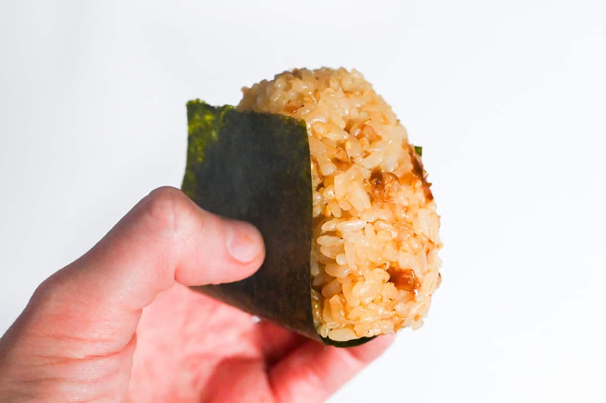 holding okaka onigiri wrapped with nori