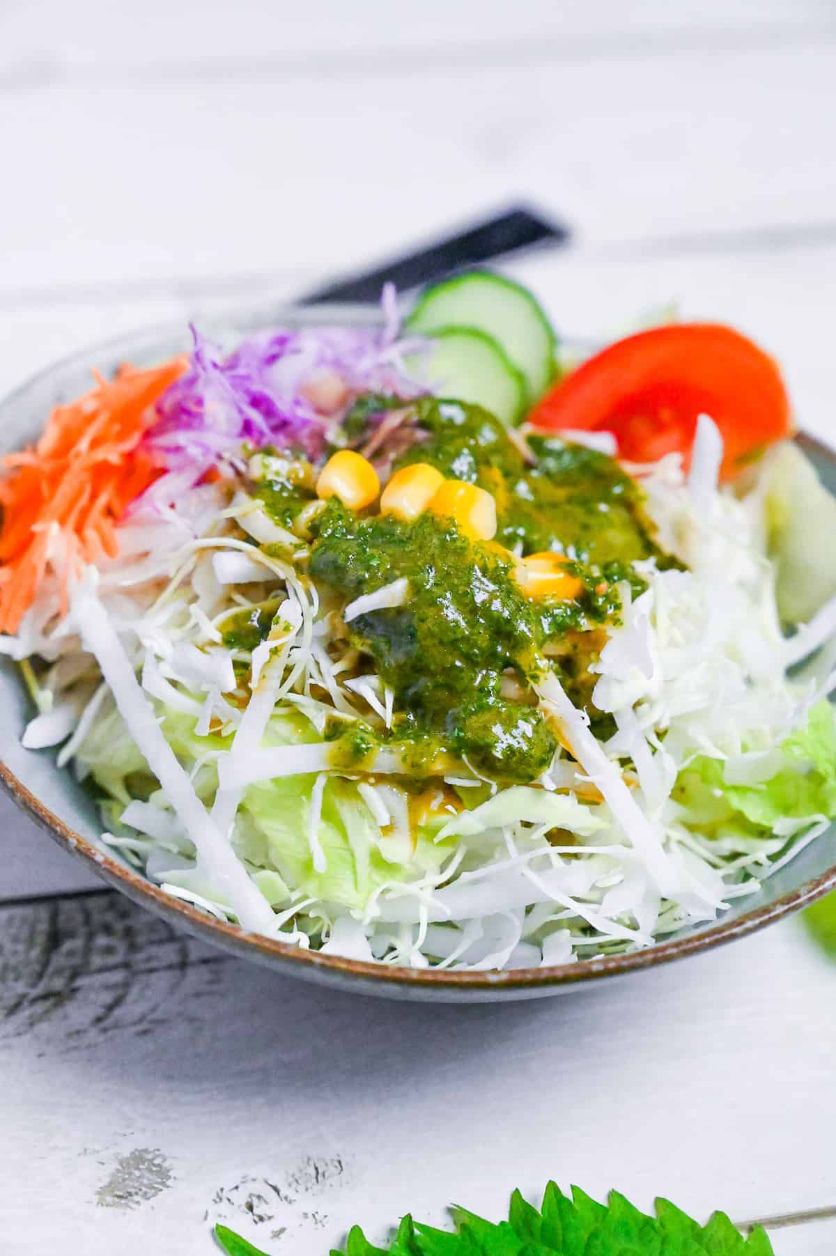 Japanese shiso dressing over a mixed salad of crunchy lettuce, carrots, cucumber, tomato and sweet corn