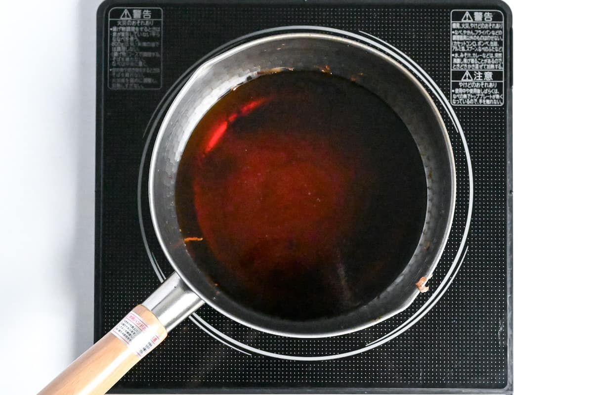 soy sauce, sake, cane sugar and water heating in a pot on the stove