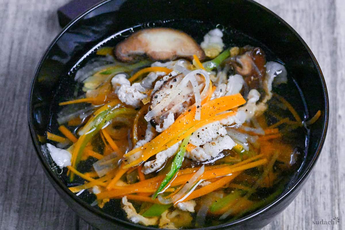 Sawaniwan (Japanese pork and vegetable soup) in a black bowl close up