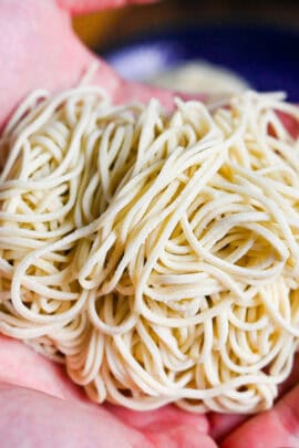 a bundle of homemade ramen noodles held in two hands