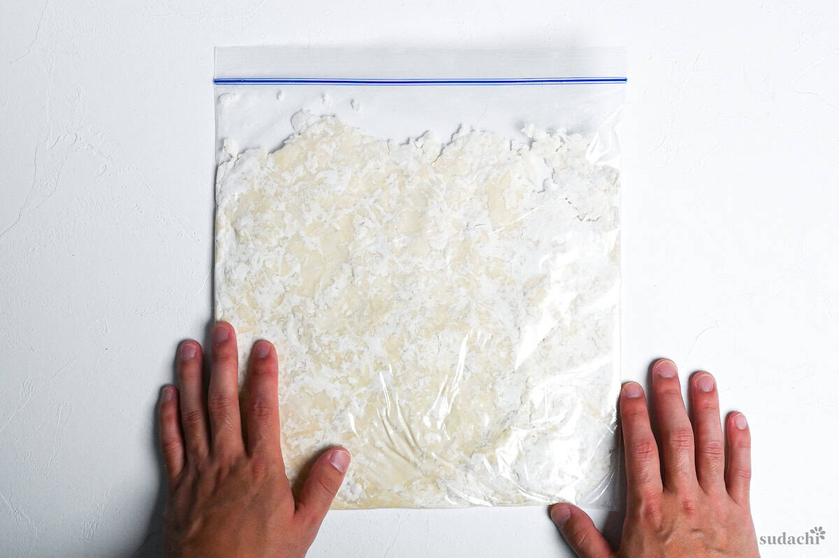 ramen noodle dough flattened to the edges in a sealed freezer bag