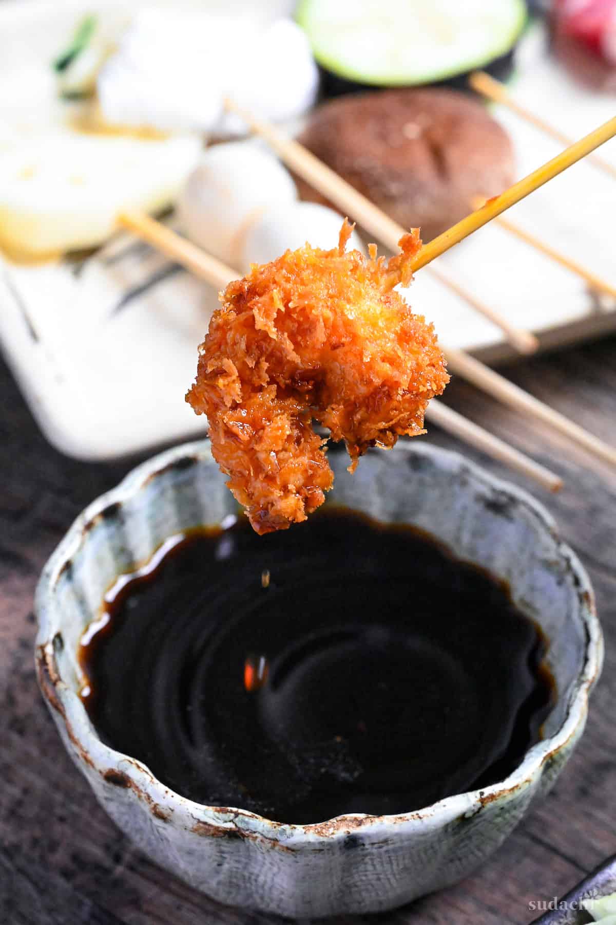 dipping shrimp kushi age in homemade sauce