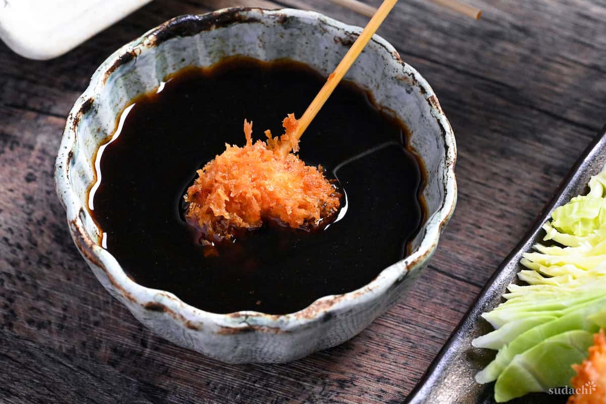 dipping kushi age in homemade sauce