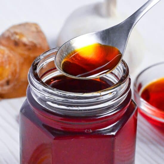 Homemade Japanese Rayu in a jar with a spoonful hovering above