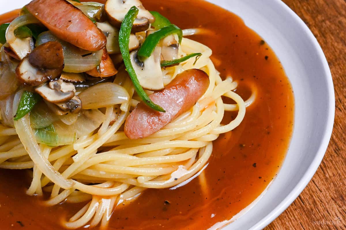 close up of ankake spaghetti on a white plate