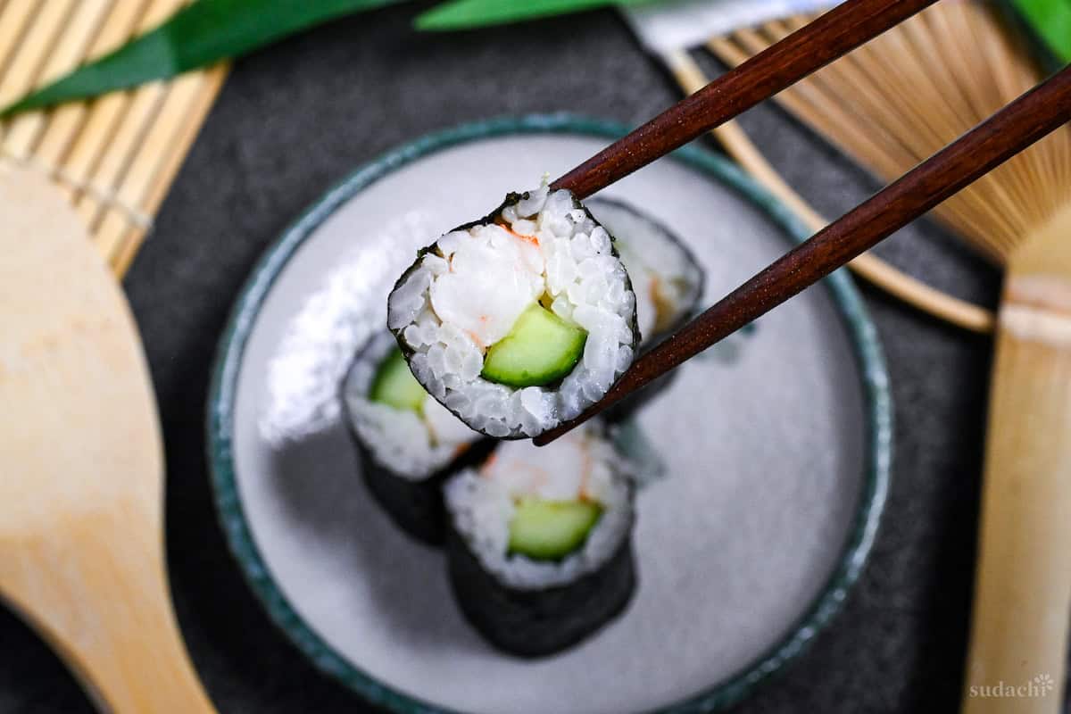 Ebikyu maki held with wooden chopsticks