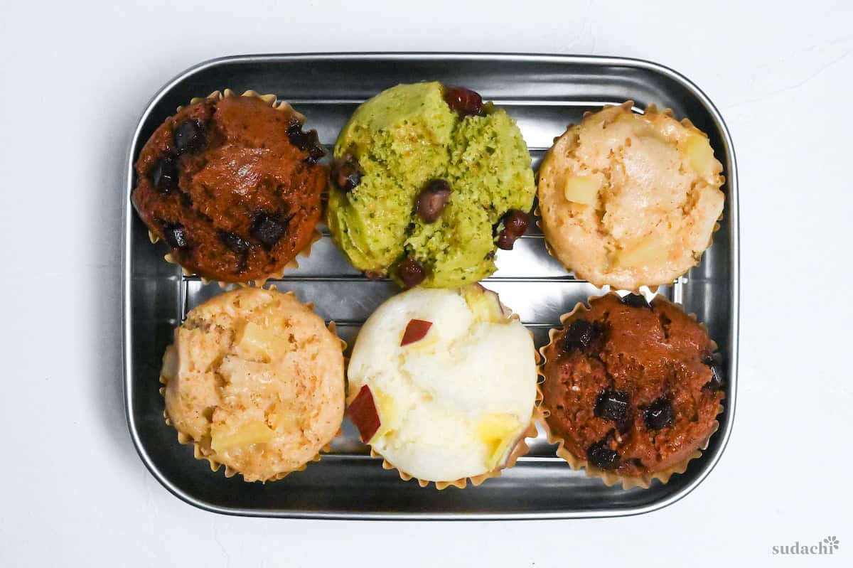 6 mushi pan on a wire rack inside a metal container on a white background