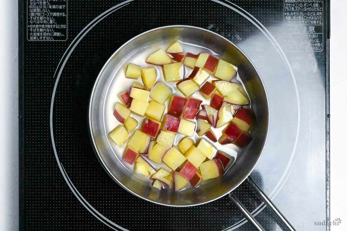 sweet potatoes simmered with water and sugar in a pot on the stove