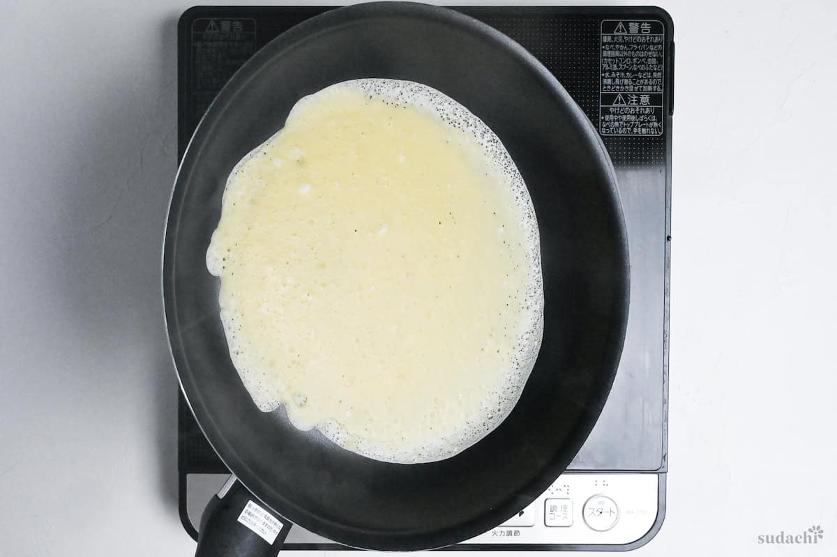 swirling pan to spread crepe batter