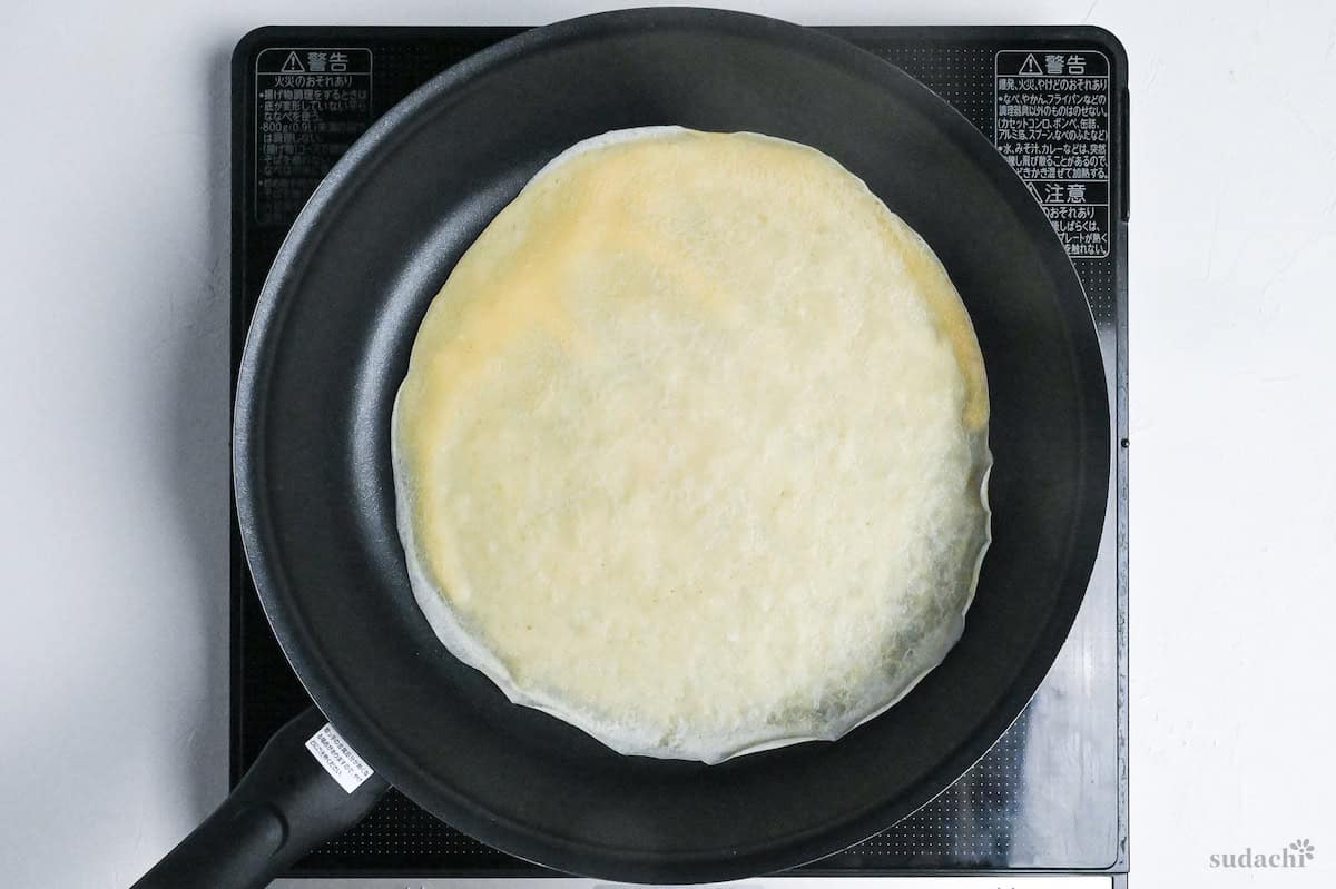 cooked crepe in frying pan