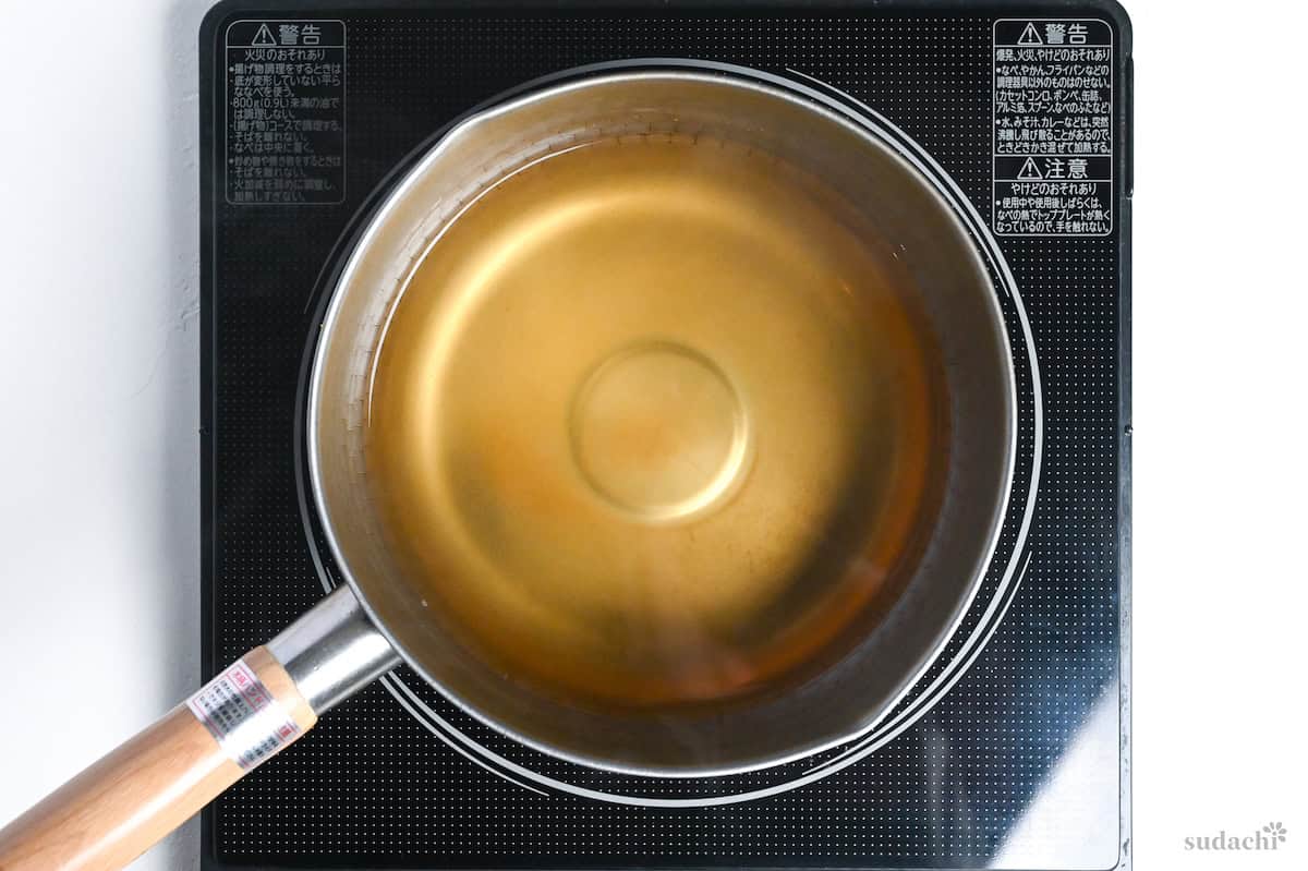 dashi heating in a pot on the stove